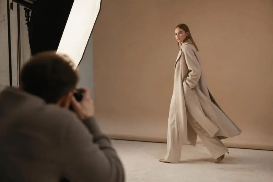 Fashion shoot in a studio with a model in a long coat